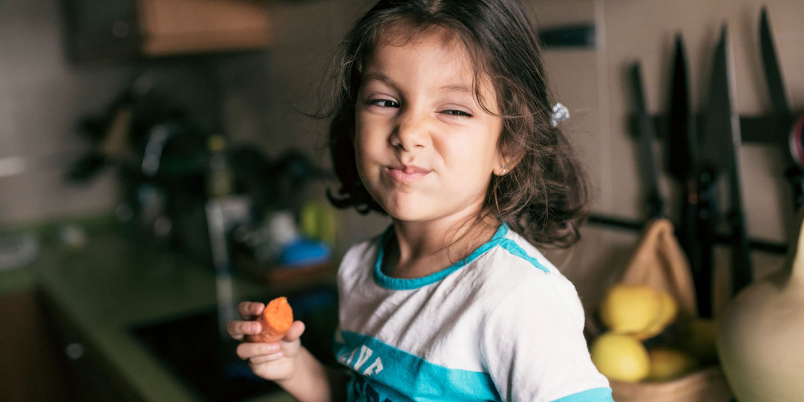 Girl eating carrot, vitamin A for eyesight